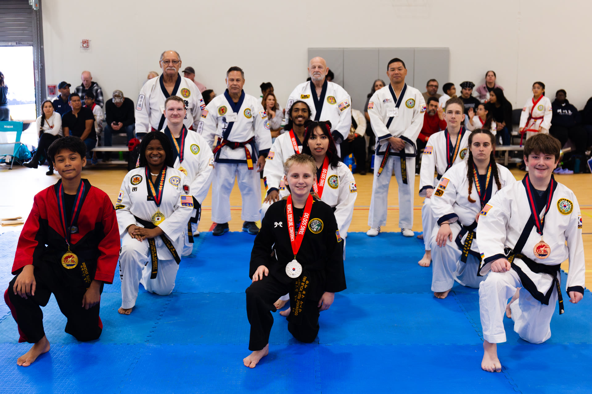 Young students posing with medals